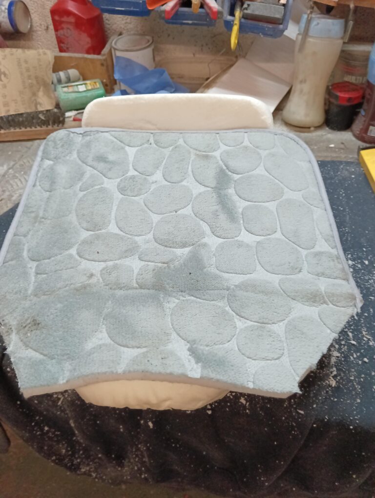 Then this soft cushion bed-topper type matirial over it all, to soften it a bit further and also widen it a bit at the front, to stop the thighs hitting the bike frame